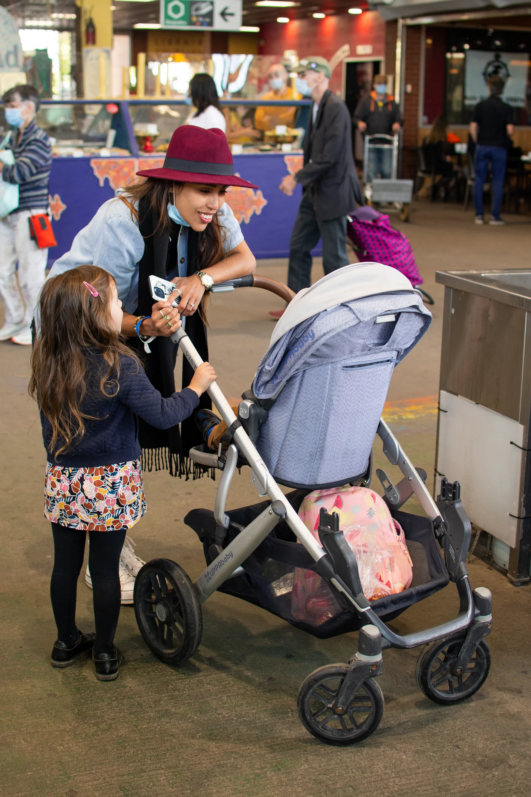 Girl and baby in stroller